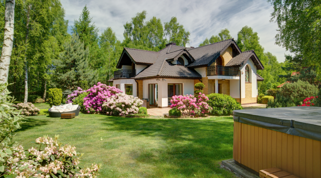 Beautiful lawn in front of a home with many trees and plants